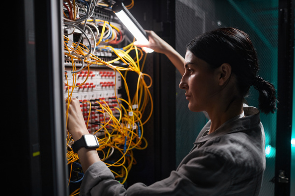 Person looking into a server cabinet 