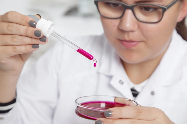 Girl Squeezing Pink Liquid Into Petri Dish Resized