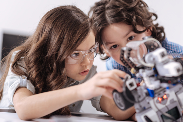 Two children looking at an automatic part