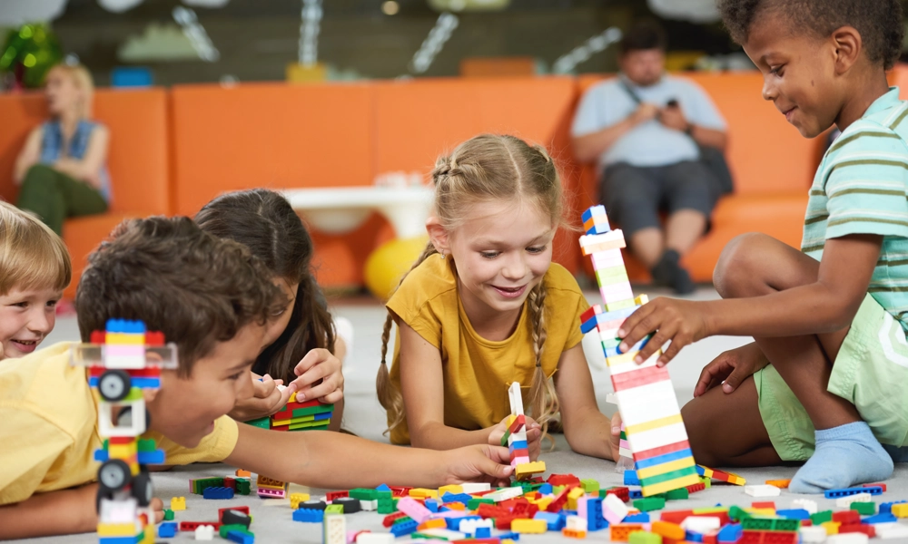 A group of children building colourful blocks