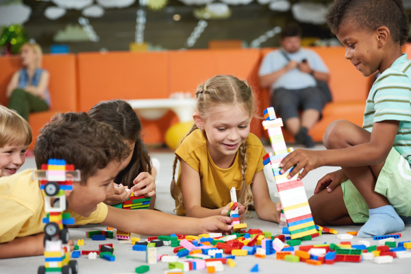 A group of children building colourful blocks