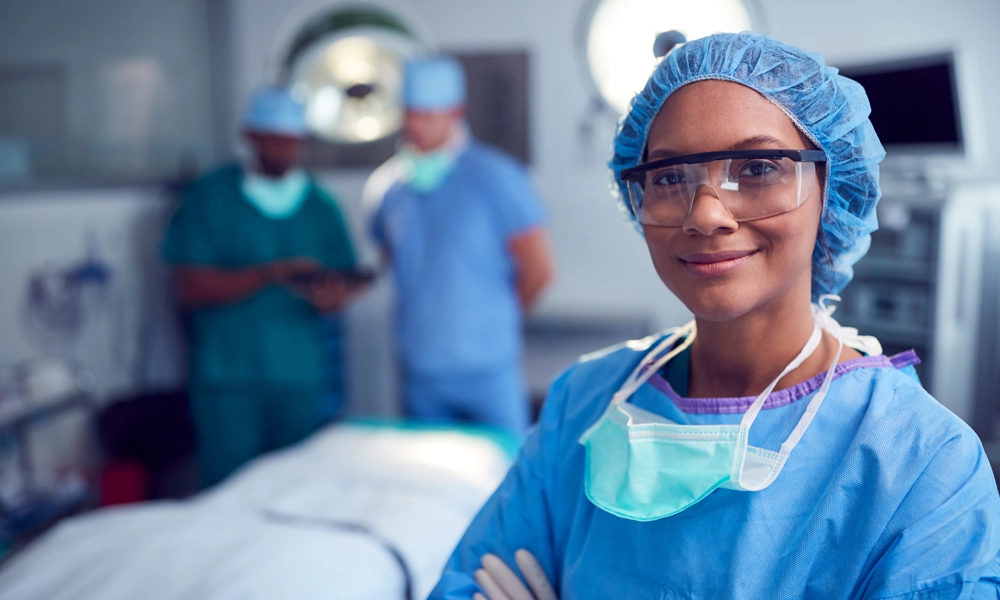 Person with safety glasses and a mask is posing in the surgery room