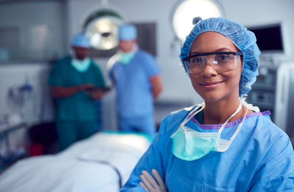 Person with safety glasses and a mask is posing in the surgery room