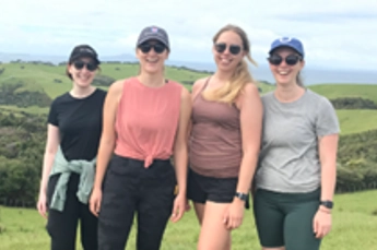 Imogen Rae standing in field with three women