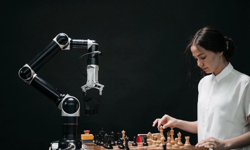 Woman playing chess against a robot