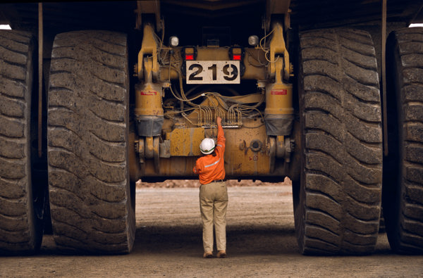Person standing in front of a huge truck