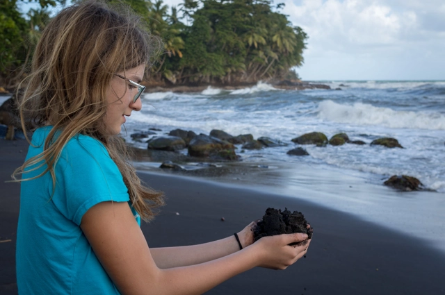 Girl Holding Soil On Beach Resized