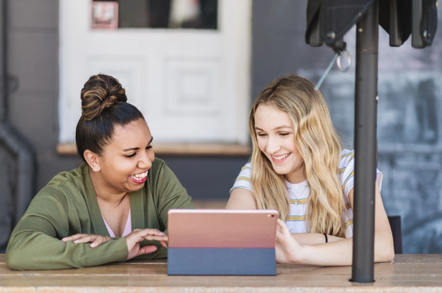 Two people working at a tablet