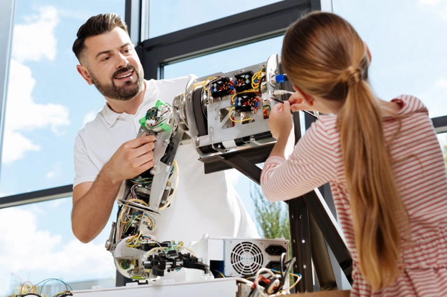 Dad And Daughter Building Robotic Device Resized