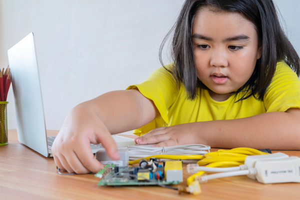 Child is working on a circuit
