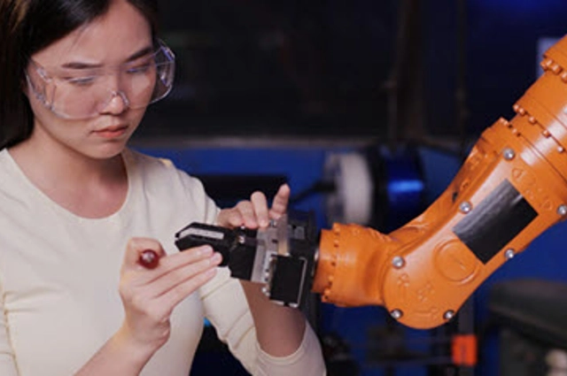 Female working with robotic arm