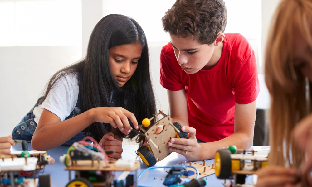 Two students working on a STEM toy