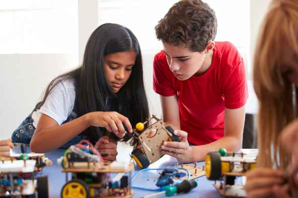 Two students working on a STEM toy