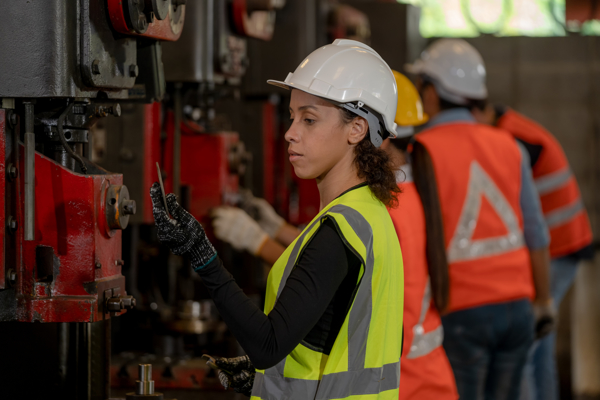 People working in front of machines